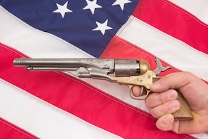 Shooting Antique Pistol Over American Flag